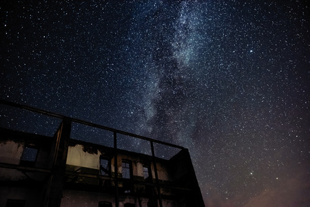 Night sky and the Milky Way over the old abandoned houseの写真素材