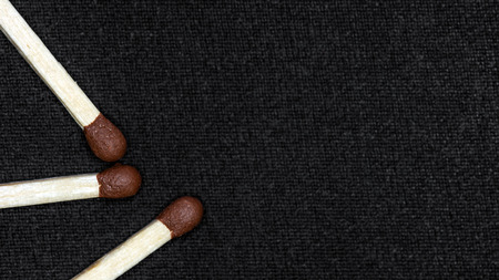 Scattered matches on a black background