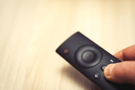 TV remote control in handの写真素材