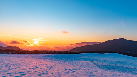 Amazing beautiful vibrant winter sunset in the mountainsの写真素材