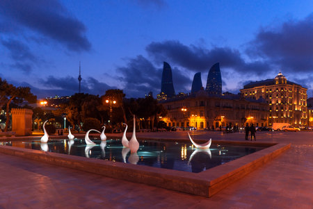 Azerbaijan, Baku, February 24, 2019 View of swans fountains  in the National Seaside Park at evening timeのeditorial素材
