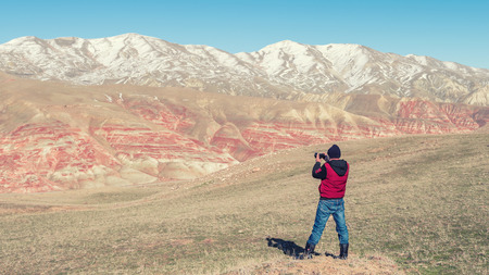 Nature photographer traveler in the red mountains