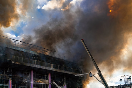 Burning building in thick toxic smokeのeditorial素材