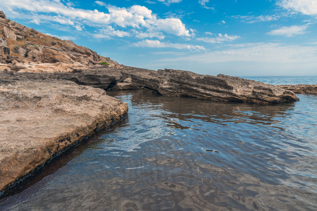 Rocky seashore with azure waterの写真素材