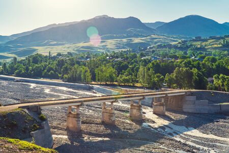 Old stone bridge over a mountain riverの写真素材