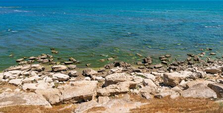 Rocky sea coast with clear waterの写真素材
