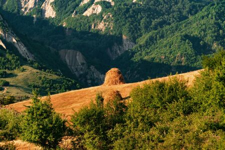 Hay stack on a hillside