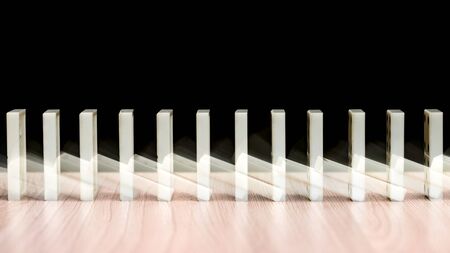 Falling domino stones on the tableの写真素材