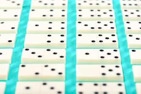 Playing dominoes on a blue wooden tableの写真素材