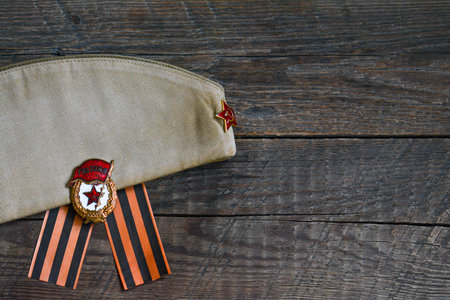 WWII soldier cap and Guard medal on wooden backgroundのeditorial素材
