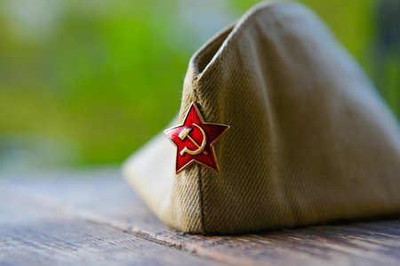 WWII russian soldier cap with red star badge, victory day backgroundのeditorial素材