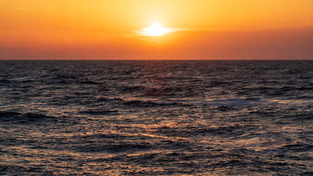 Dark dramatic sunset over the seaの写真素材