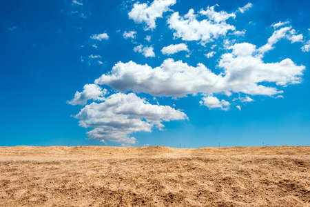 Yellow sand and blue cloudy skyの写真素材