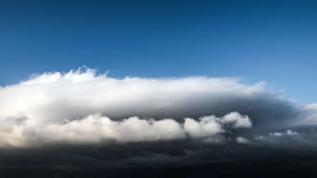 Sky with clouds and a dark thundercloud is approaching stormの写真素材