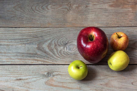 Big red apple on wooden table