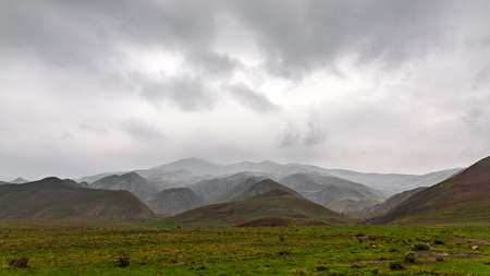 Panorama of mountains in rainy cloudy weatherの写真素材