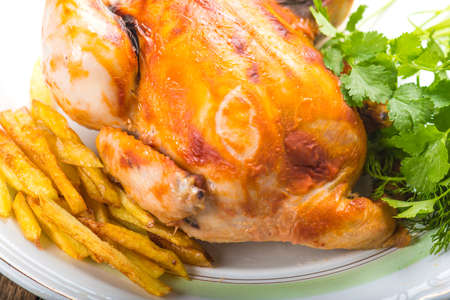 Fried chicken with potatoes on a plateの写真素材