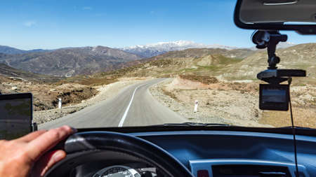 View of the road in the mountains through car windshieldの写真素材