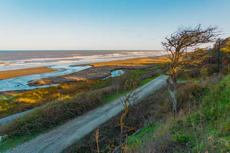 Dirt road along the sea coastの写真素材
