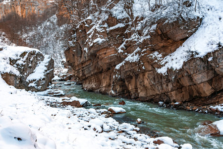 Fast mountain river in the gorge at winter seasonの写真素材
