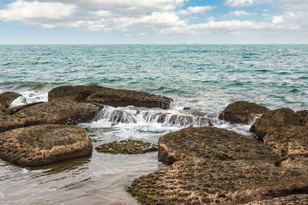 Rocky sea coast at cloudy weather
