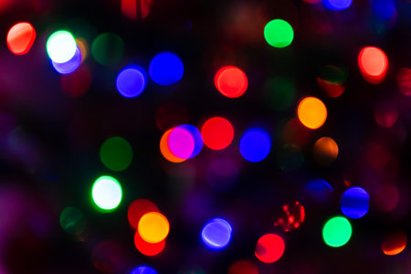 Multicolored christmas bokeh lights backgroundの写真素材