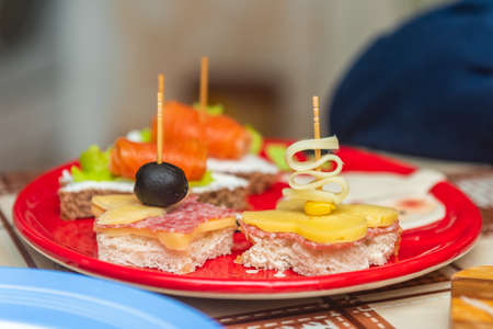 Sandwiches with cheese and red fish on a plateの写真素材