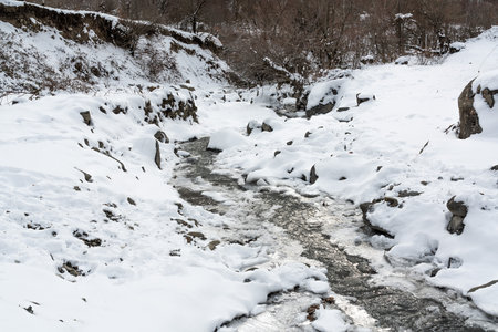 Frozen mountain river in winterの写真素材