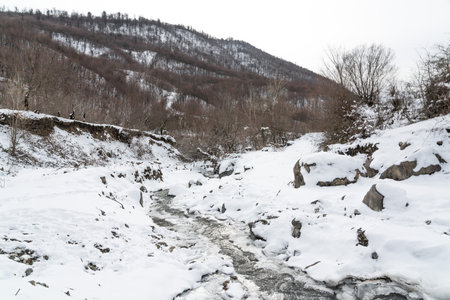 Frozen mountain river in winterの写真素材