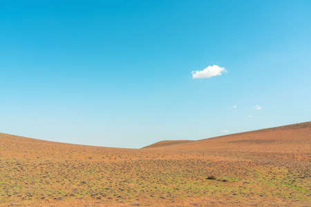 Lonely cloud over mountain meadow landscape minimalismの写真素材
