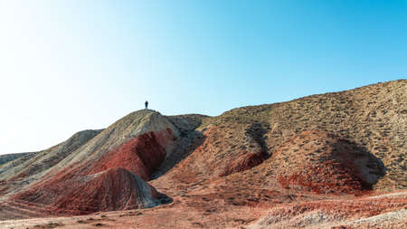 Photographer takes pictures of a beautiful red sandy mountainの写真素材