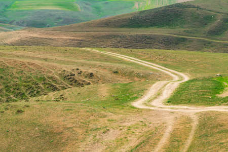 Winding dirt road in the mountainsの写真素材