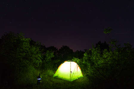 Light in a tent camping at nightの写真素材