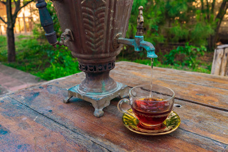 Tea drinking from a vintage samovar in garden