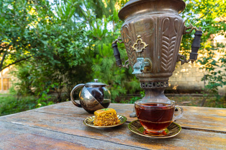 Tea drinking from a vintage samovar with oriental sweetsの写真素材