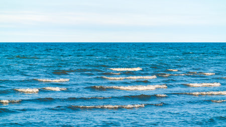 Turquoise sea and horizon with cloudsの写真素材