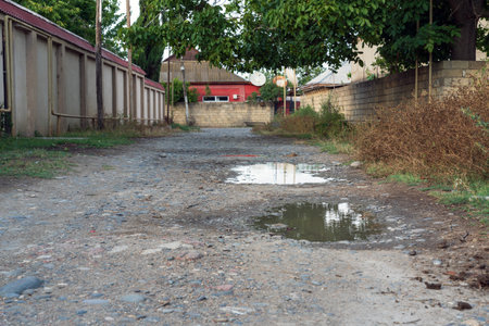 Puddle after rain on a dirt roadの写真素材