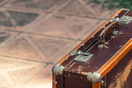 Old shabby leather suitcase by the carの写真素材