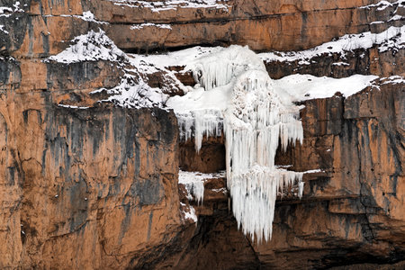 Frozen waterfall in the mountainsの写真素材