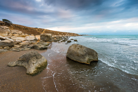 rocky sea coast in cloudy weatherの写真素材