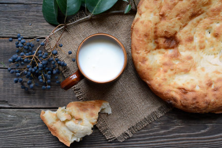 Mug of milk and freshly baked asian bread on wooden table top viewの写真素材