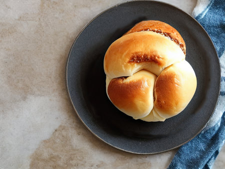 Homemade buns with poppy seeds on a plate, top viewの素材