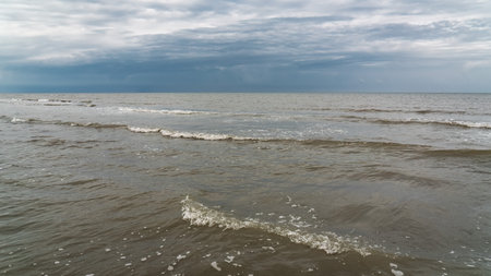 Sea shore in cloudy weather with thundercloudsの写真素材