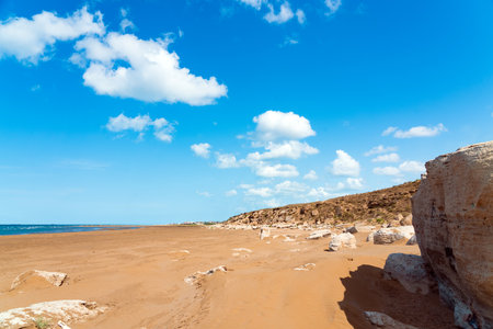 Large sandy beach with stone bouldersの写真素材