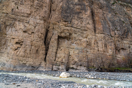 Mountain river flow near big rockの写真素材