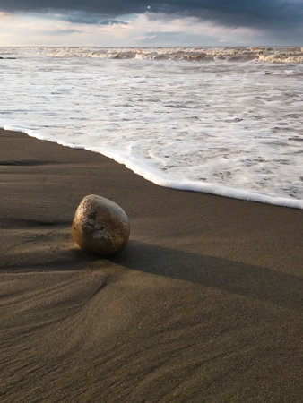 Round boulder on the seashoreの写真素材