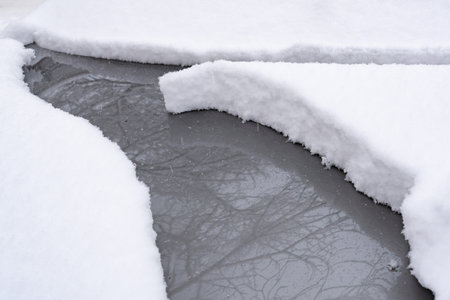 Car covered with snow after a heavy snowfall in the city.の写真素材