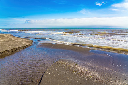 A small river flows into the seaの写真素材