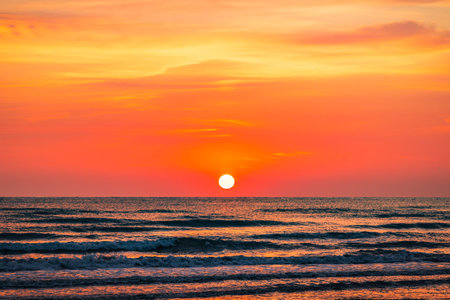 Colorful sunrise on the sea sandy beachの写真素材