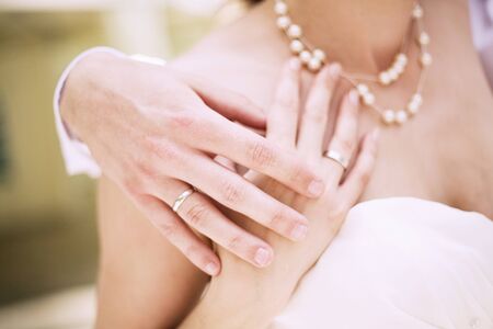 Close-up of the hands of a newly wed coupleの写真素材